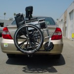 TRILIFT Ultra Lite carrying a manual wheelchair on a Toyota Camry.
